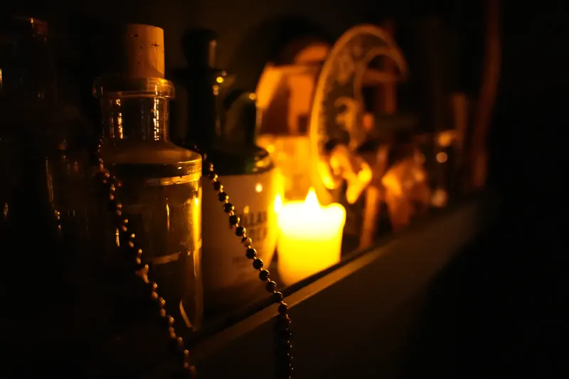 Candle and antique bottle inside Maelstrom