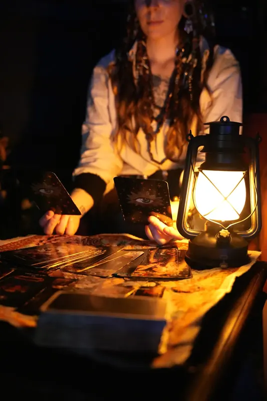 Tarot reading by lantern light inside Maelstrom
